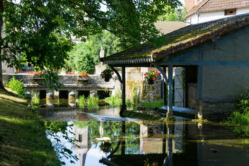 Lusigny sur Ouche old Wash-house (Lavoir) in Burgundy. River and antique bridge.