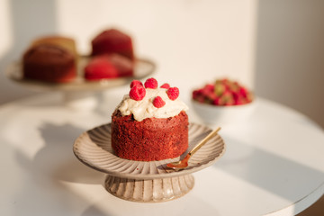 Delicious cupcakes with berries on stand over white background
