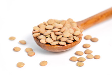 Lentil on wooden spoon with white background