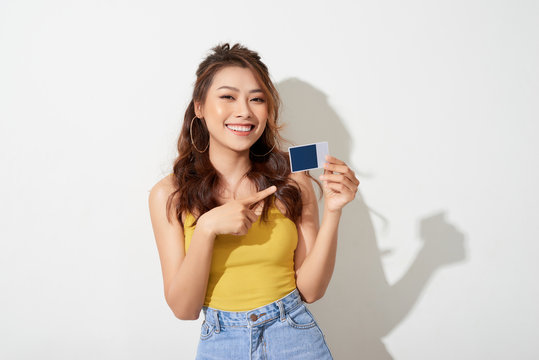 Photo Of Young Smiling Asian Woman Holding Card