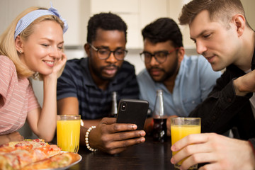 Obraz premium Young friends eating pizza at home
