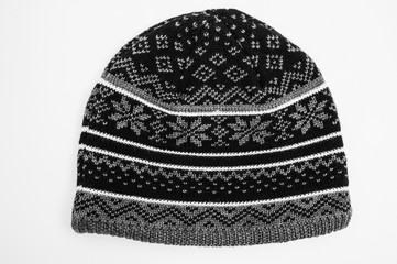 grey black striped snowflake patterned beanie isolated for wintertime on white background