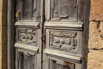 Vintage wooden door in abandoned clay arabian house, old building ruins in dagesnta city, russian