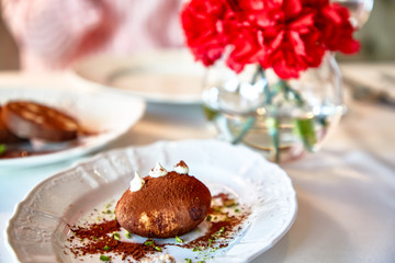 Traditional dessert of the USSR and Russia-kartoshka is on a plate in the restaurant