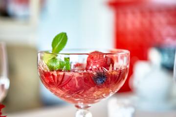 Strawberry dessert with mint is on a glass plate in the restaurant