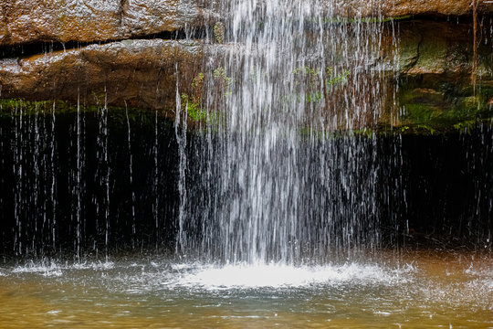 Close up of waterfall dropping into pond, Chapada dos Guimar&atilde;es, Mato Grosso, Brazil, South America