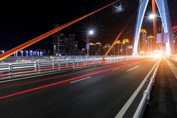 Fototapeta na wymiar Urban road and bridge buildings pass through the financial district in Chongqing at night,China.