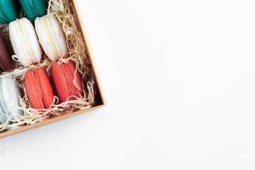 Top view on a gift box of colorful French macaroons. Close-up.