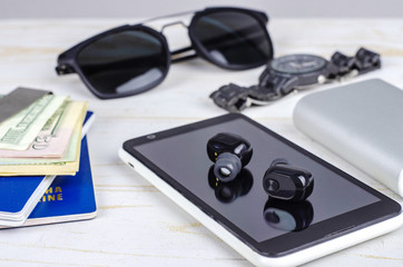 Business set with passport, money, watch, smartphone, sunglasses, wireless headphones