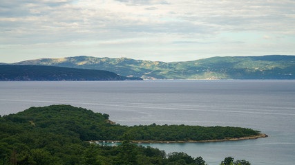 View of the sunlit coast of the island of Cres from the island of Krk, Adriatic