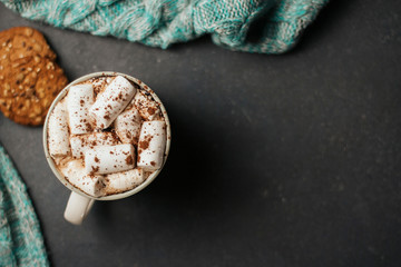  Cup of coffee or cocoa with marshmallows and cookies on a dark gray background.