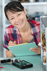 female computer technician holding clipboard