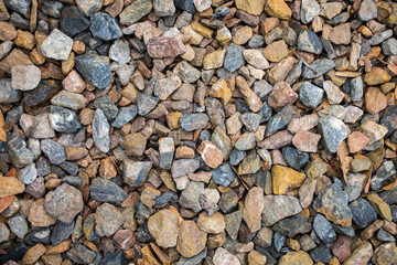 Top view of blue and brown construction gravel texture background.