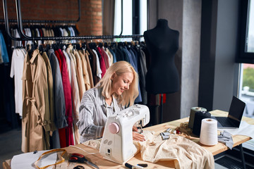 young talented seamstress enjoying her work, happiness concept,