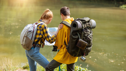 archeologists checking map before the expedition. close up back view photo.