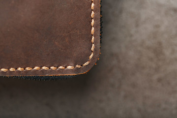 Organizer wallet made of brown Genuine leather, handmade on a dark background