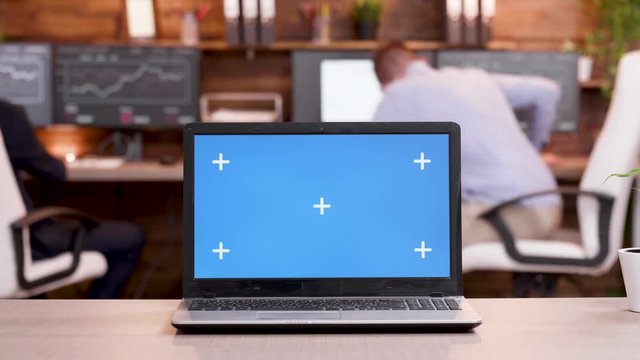 Laptop in a modern workplace with empty screen. Green screen. Screen mock-up