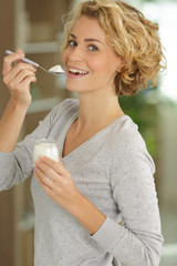 young woman with yogurt indoors