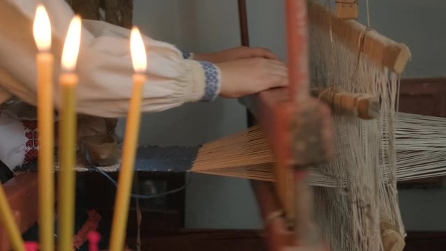 weaver makes fabric in ethnic loom