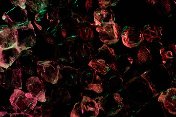 top view of clear ice cubes with red and green illumination isolated on black