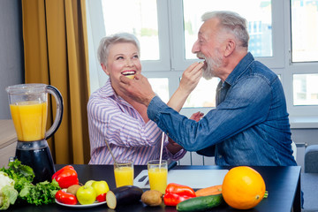 Senior couple drinking vegan smoothie with organic fruits and vegatables from eco glasses and reusable tubes
