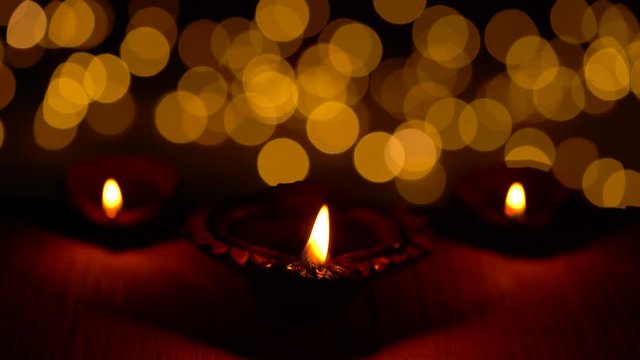 Diwali Deccoration With Diya. Happy Diwali Celebration with diya or oil lamps. Deepavali, Deepabali, deepwali is widely celebrated in India & all over the world. Dark moody video clip of diya or lamp.