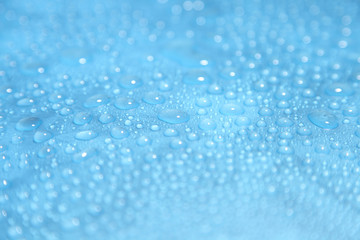 Naklejka na ściany i meble Close up water drops on blue background, Water drop in macro photography