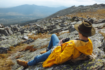 young ambitious man holding binoculars looking at the horizon. close up side view photo