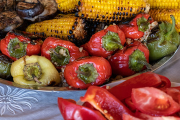 Grilled vegetables on plate on wooden background. Pepper, corn and eggplant cooked on grill. BBQ. Barbecue. Organic salad