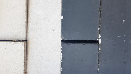 black and white bricks piled equally in a pile. Close-up. Black-white stone background