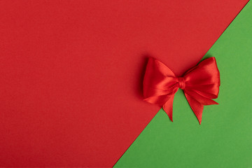 red bow on red and green background, Letter or invitation. New year concept. Copy space and template