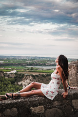 Rocca Imperiale, Italy - August 2019: View from the ancient village of Rocca Imperiale, in Calabria, during a sunset in August con una ragazza che guarda l'orizzonte