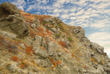 slope of stony hill on the blue sky background