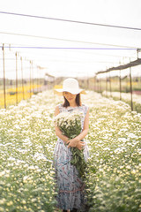 portrait of a beautiful woman in a field with flowers