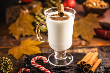 Traditional Christmas drink eggnog with grated nutmeg and cinnamon. Selective focus.