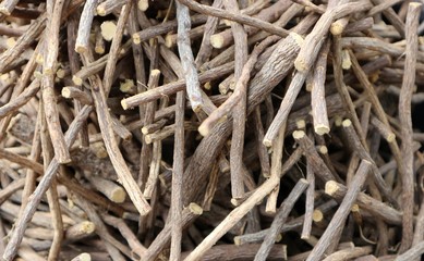 Scattered and stacked licorice roots in a heap. Food background.