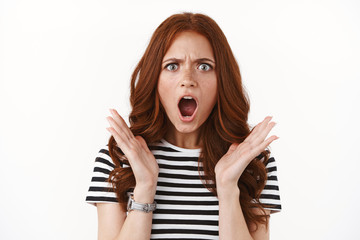 Outraged upset angry redhead girl in striped t-shirt, wristwatch furrow eyebrows, open mouth...