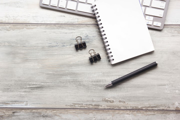 White desk office with laptop, smartphone and other work supplies with cup of coffee. Top view with...