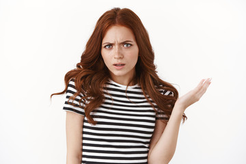 Wtf you talking about. Intense and confused outraged, pissed young redhead girl in striped t-shirt...