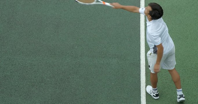 A Tennis player serves.