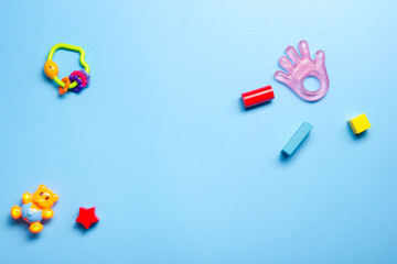 Colorful kids toys frame on wooden background. Top view. Flat lay. Copy space for text.