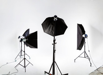 Large photostudio with lighting equipment on background of white cyclorama