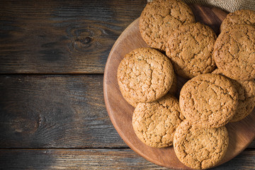 Oatmeal cookies on a wooden round Board. Rustic style. Top view