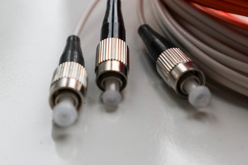 closeup of black connectors of optical fiber network cable isolated on white background