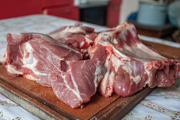 Fresh meat on a cutting wooden board at home. Cooking fresh food at home.