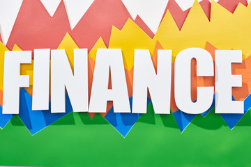 top view of finance inscription above color statistic graphs on white background