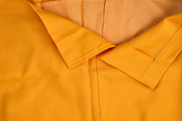 Wrong part of clothes. Lapel orange color. Close-up