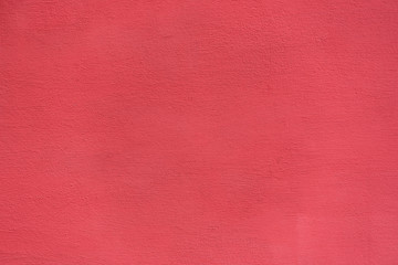 Fototapeta premium Bright rough plastered surface. Living coral colored. Backgrounds and textures