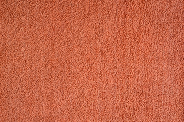Fototapeta premium Smooth seamless texture of a terry towel. Coral color