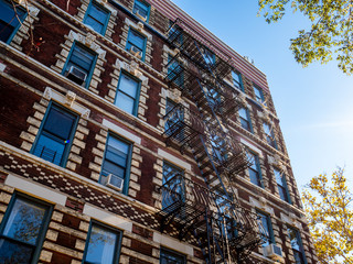 classic downtown New York City brick building facade with trees